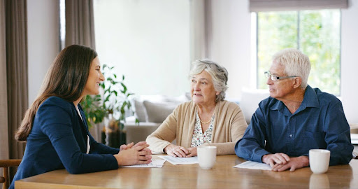 financial planner meeting with elderly couple